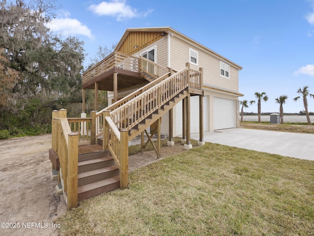 exterior space featuring a wooden deck, a garage, and a front yard