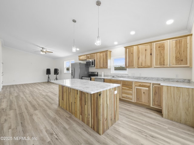 kitchen featuring decorative light fixtures, light hardwood / wood-style flooring, ornamental molding, a kitchen island, and stainless steel appliances