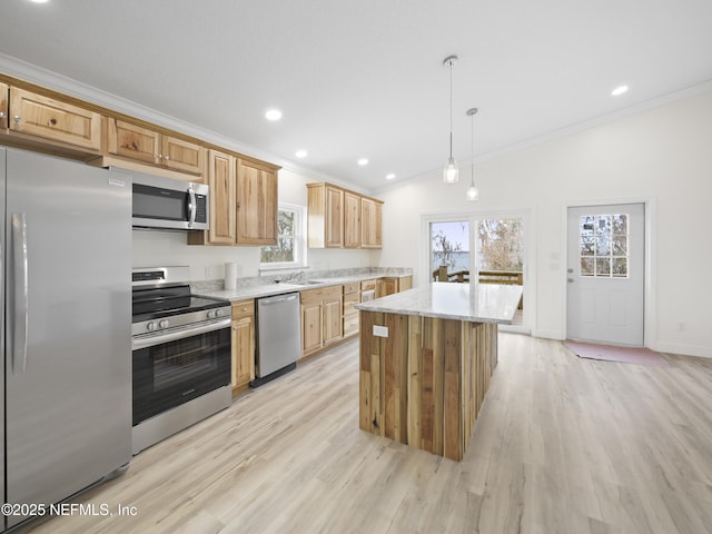 kitchen with light hardwood / wood-style flooring, stainless steel appliances, ornamental molding, a kitchen island, and decorative light fixtures