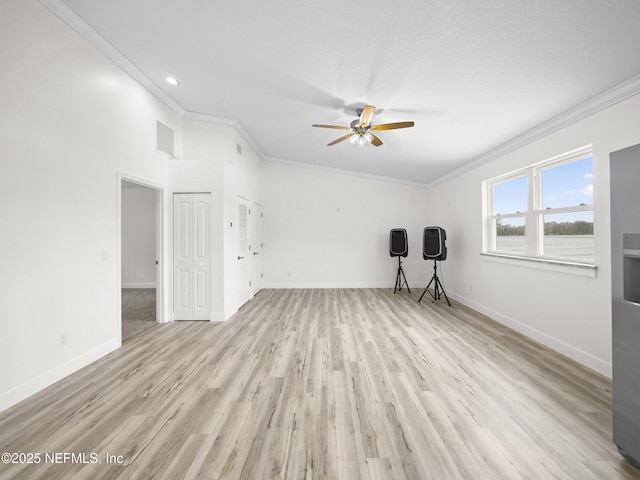 spare room with crown molding, ceiling fan, and light hardwood / wood-style floors