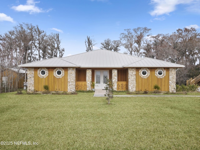 single story home with a front yard and french doors