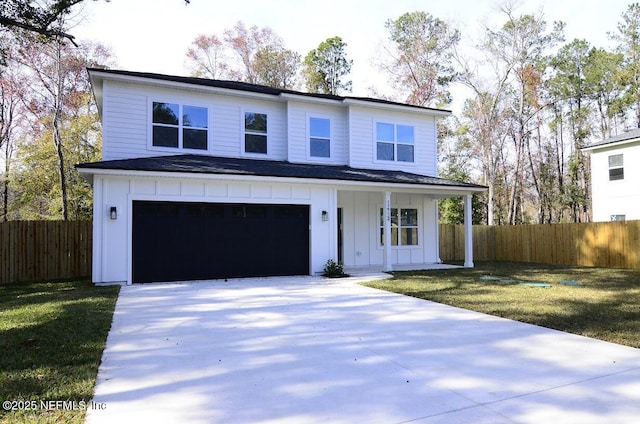 view of front of home with a garage and a front lawn