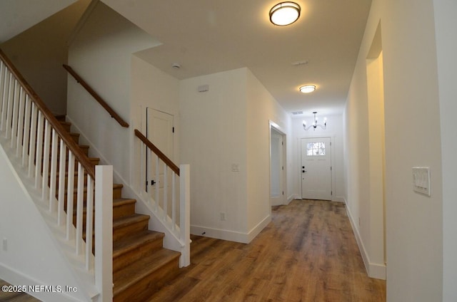 interior space with wood-type flooring and a notable chandelier