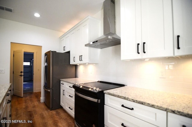 kitchen with black / electric stove, white cabinetry, wall chimney range hood, and light stone counters