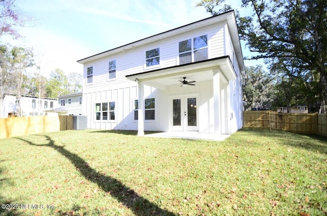 rear view of house featuring ceiling fan, a patio area, a lawn, and french doors