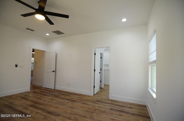 unfurnished bedroom with ceiling fan and dark hardwood / wood-style flooring