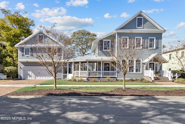 view of front of house with a garage, a porch, and a front yard