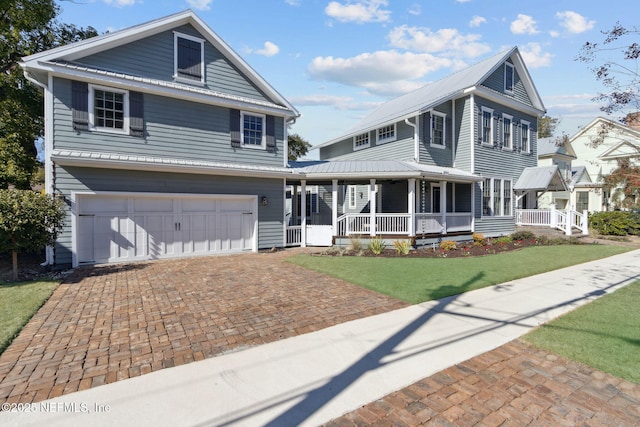 view of front of house featuring a garage, a front lawn, and a porch