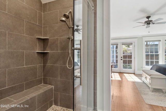 bathroom featuring a tile shower, hardwood / wood-style flooring, and ceiling fan