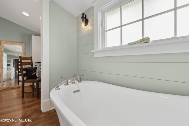 bathroom featuring wood-type flooring and a bathtub