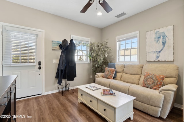 living room with dark hardwood / wood-style floors and ceiling fan