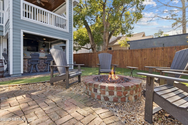 view of patio / terrace with a balcony and a fire pit