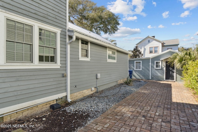 view of side of property featuring a patio area