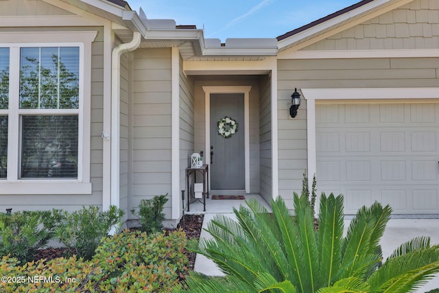 view of exterior entry with a garage