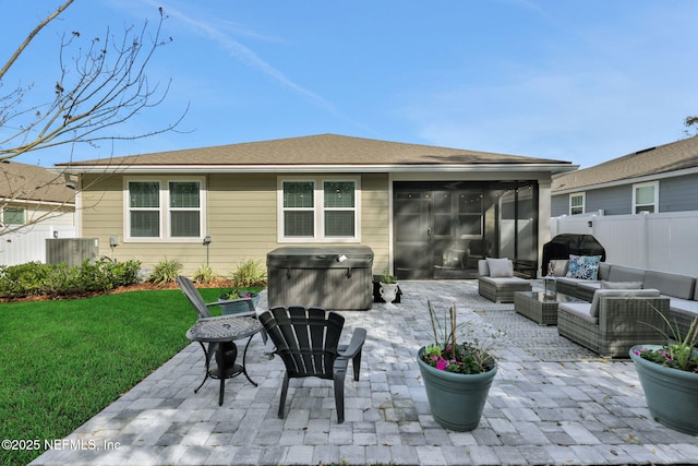 back of house featuring a patio, an outdoor hangout area, fence, a yard, and a hot tub