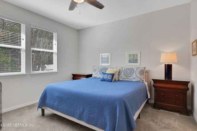 bedroom featuring carpet, multiple windows, baseboards, and ceiling fan