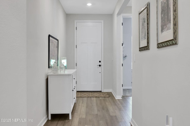 interior space featuring light wood-style flooring and baseboards