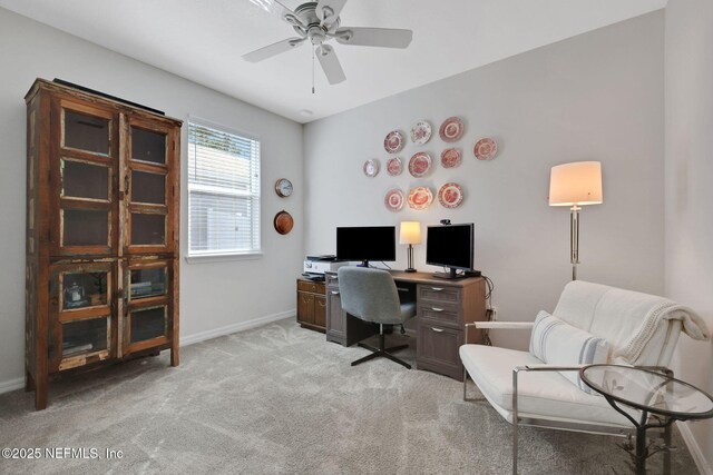 office space featuring light carpet, ceiling fan, and baseboards