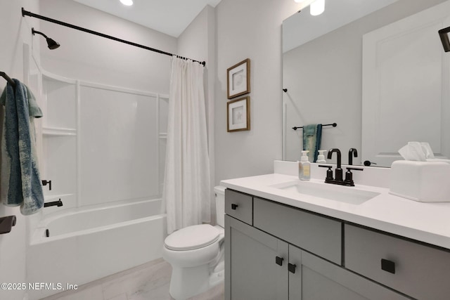 bathroom featuring toilet, marble finish floor, shower / bath combo, and vanity