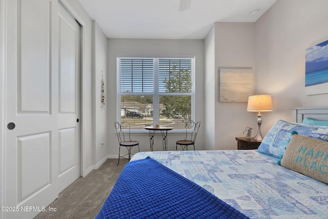 bedroom with ceiling fan, carpet flooring, and baseboards