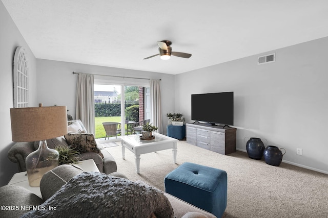 carpeted living room featuring ceiling fan