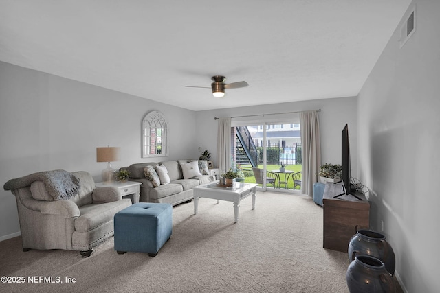 carpeted living room featuring ceiling fan