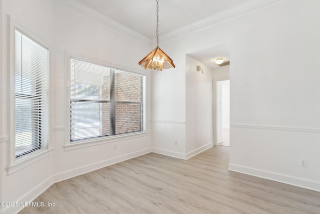 empty room featuring ornamental molding and light hardwood / wood-style floors