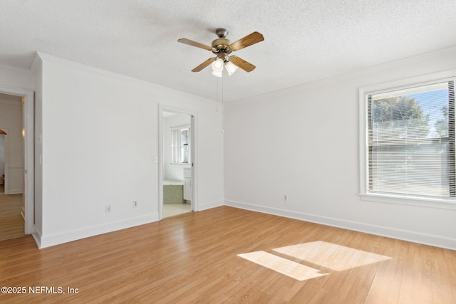 unfurnished bedroom featuring crown molding, ceiling fan, connected bathroom, a textured ceiling, and light wood-type flooring