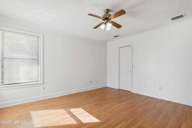 unfurnished room featuring ceiling fan, crown molding, a textured ceiling, and hardwood / wood-style flooring