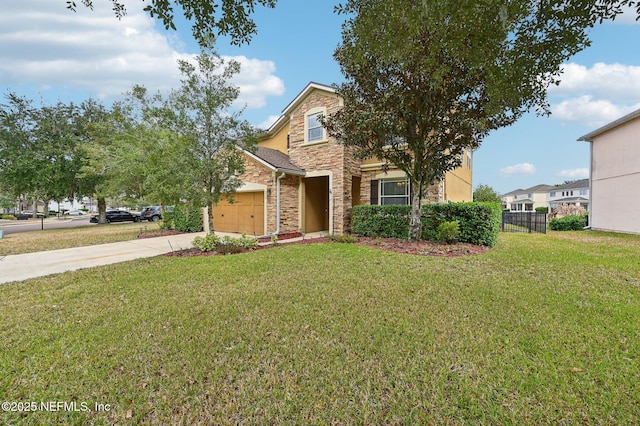 view of front of property featuring a garage and a front lawn