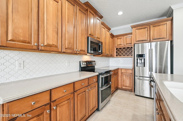 kitchen with light tile patterned flooring, appliances with stainless steel finishes, backsplash, crown molding, and a textured ceiling