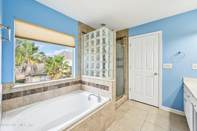 bathroom with tile patterned floors, vanity, and independent shower and bath