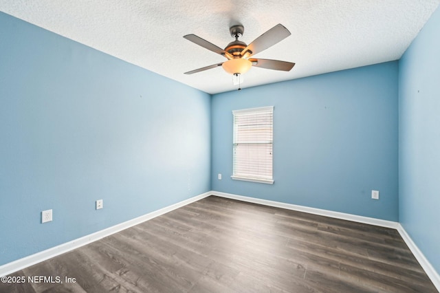 spare room featuring ceiling fan, dark hardwood / wood-style floors, and a textured ceiling