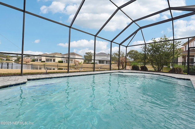 view of pool with glass enclosure