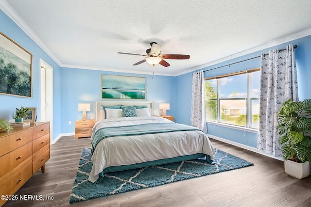 bedroom with ceiling fan, ornamental molding, dark hardwood / wood-style floors, and a textured ceiling