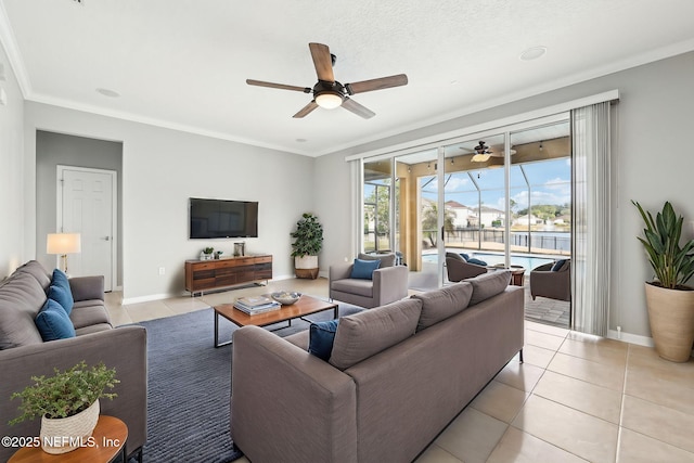 living room featuring light tile patterned flooring, ceiling fan, and ornamental molding