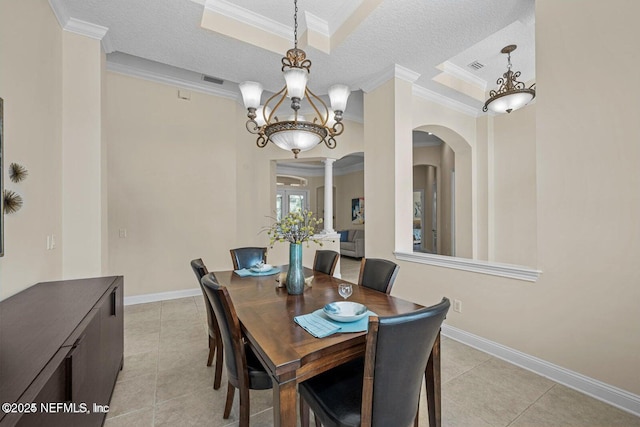 dining area with decorative columns, a textured ceiling, ornamental molding, and light tile patterned flooring