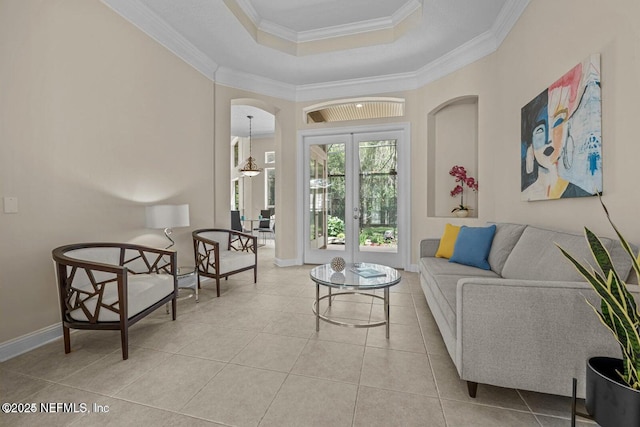 living area featuring light tile patterned floors, ornamental molding, a raised ceiling, and french doors