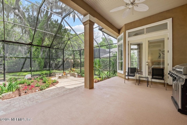 unfurnished sunroom with ceiling fan