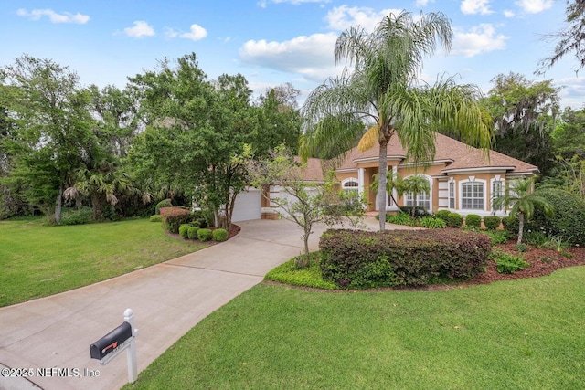 view of front of house featuring a garage and a front yard