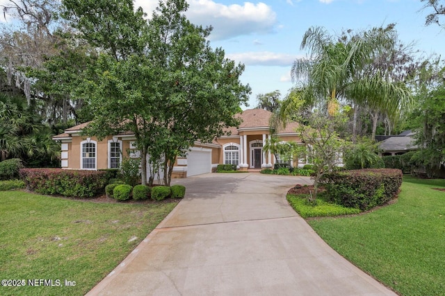 view of front of home featuring a garage and a front yard