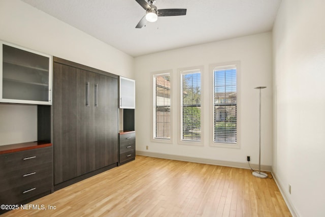 unfurnished bedroom featuring light hardwood / wood-style floors and ceiling fan