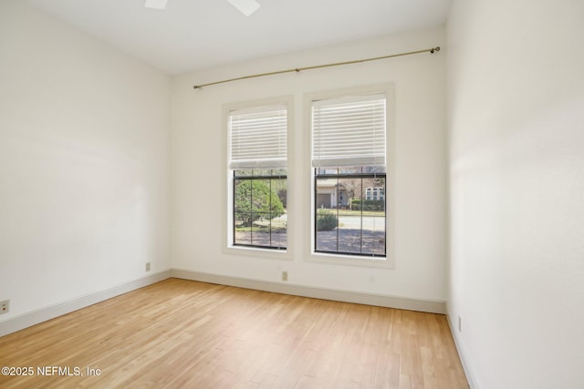 spare room with light hardwood / wood-style flooring and ceiling fan