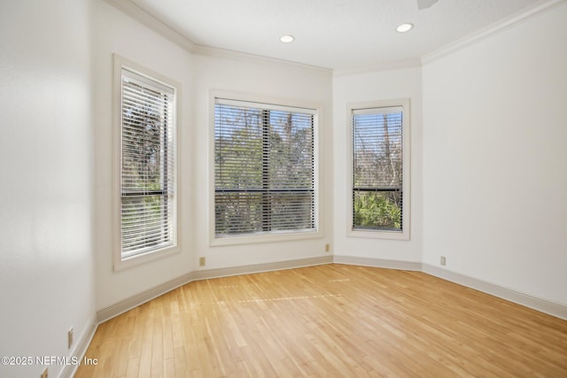 empty room with ornamental molding and light hardwood / wood-style floors