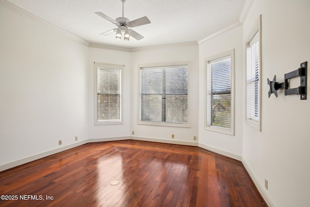 spare room with ceiling fan, ornamental molding, dark hardwood / wood-style floors, and a textured ceiling