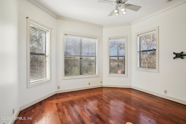 empty room with ornamental molding, dark hardwood / wood-style floors, and ceiling fan