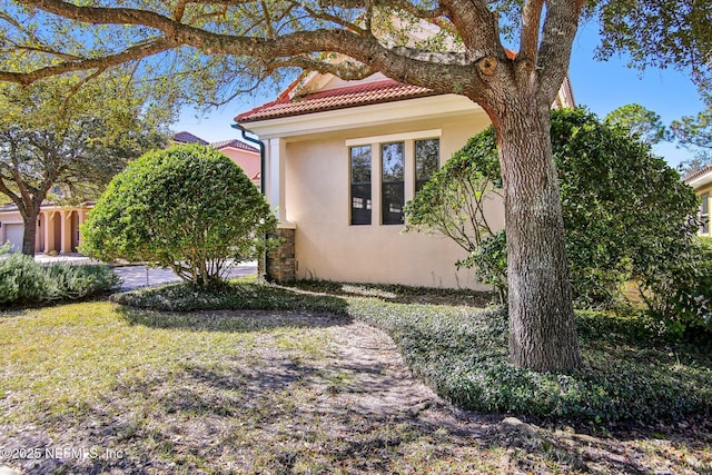 view of property exterior with a lawn