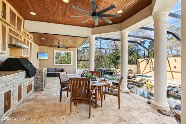 view of patio with ceiling fan, an outdoor kitchen, a grill, and an outdoor hangout area