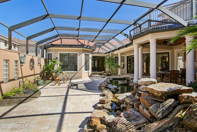 view of patio / terrace featuring a lanai