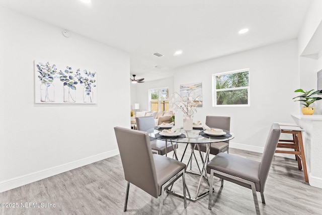 dining room with light wood-type flooring and ceiling fan